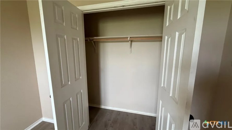 A room with a white door and a white wall.