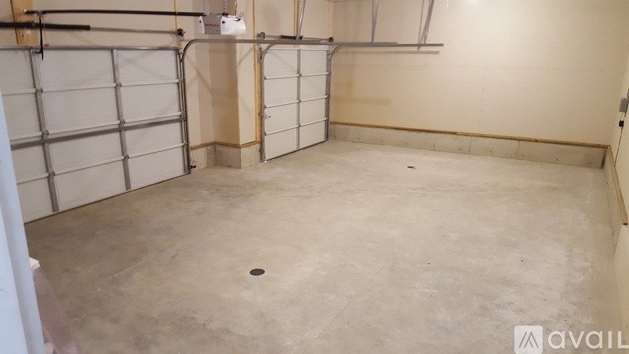 A large empty room with a concrete floor and walls.