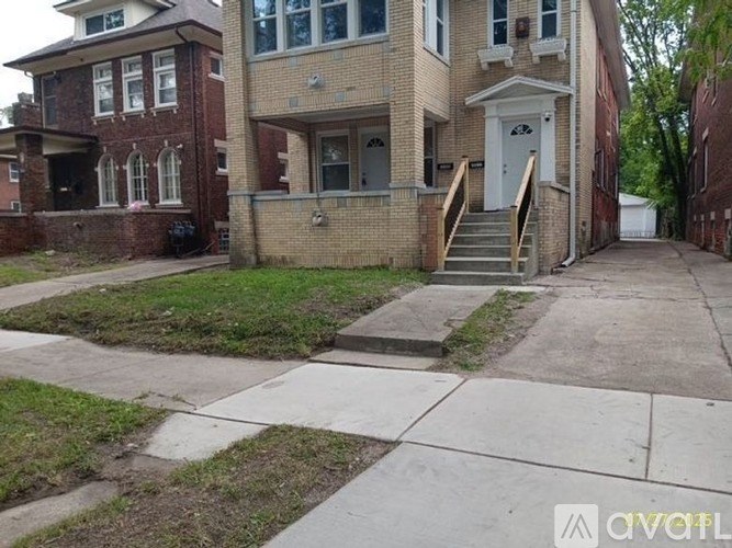 A brick house with a white door and windows.