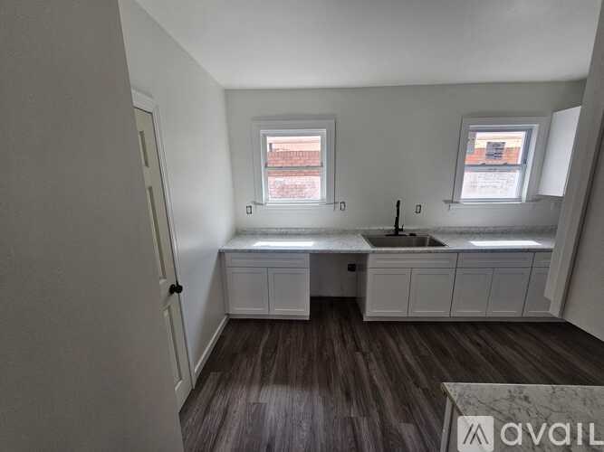 A kitchen with a sink and a window.
