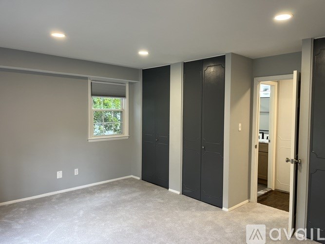 A room with grey walls and a window.