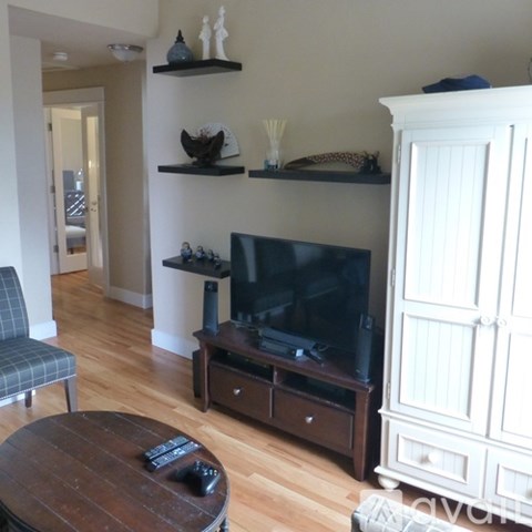 A living room with a television and a chair.
