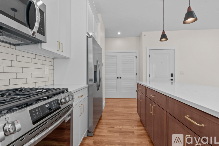 A modern kitchen with a stove top oven and a microwave above it.