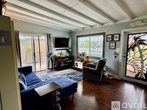 A living room with a blue couch and a television.
