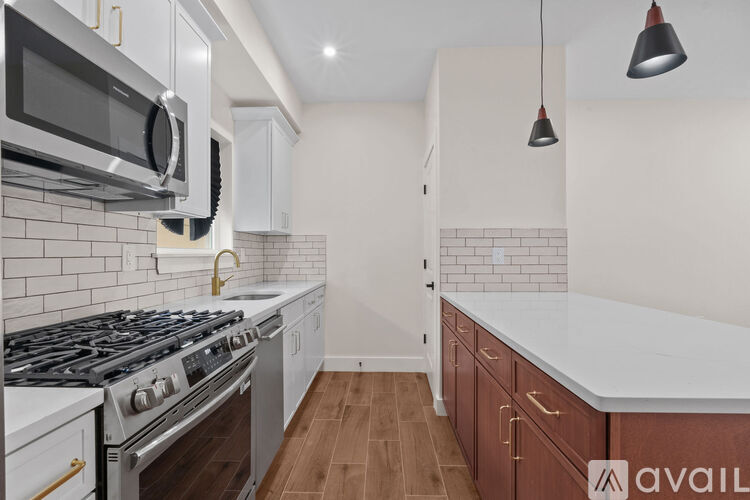 A kitchen with a stove top oven and microwave above it.
