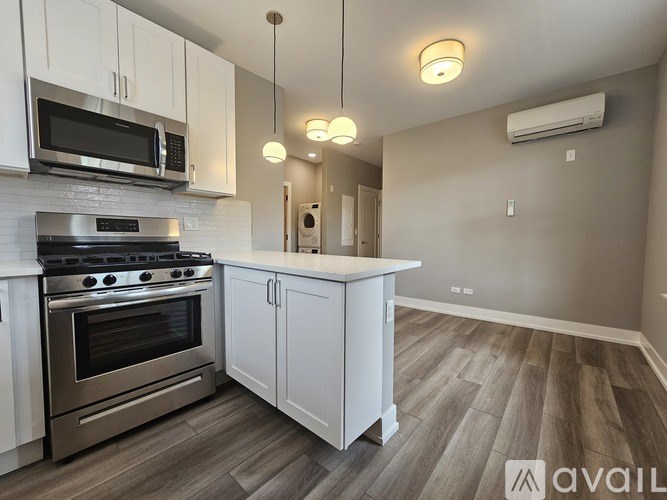 A kitchen with a stove top oven and microwave above it.
