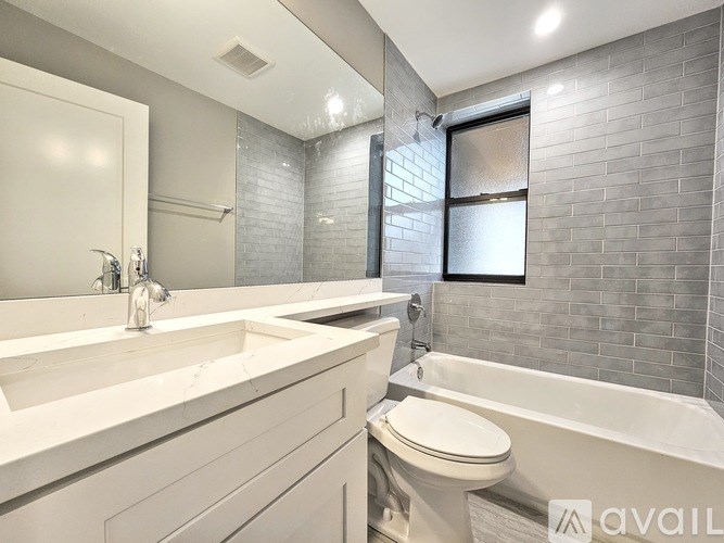 A bathroom with a white toilet and a white sink.