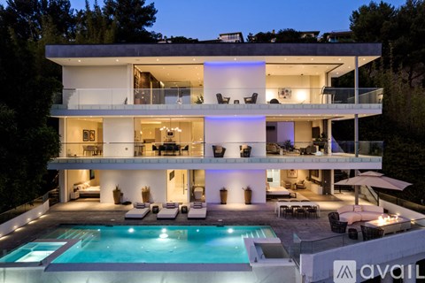 A modern house with a pool in the backyard.