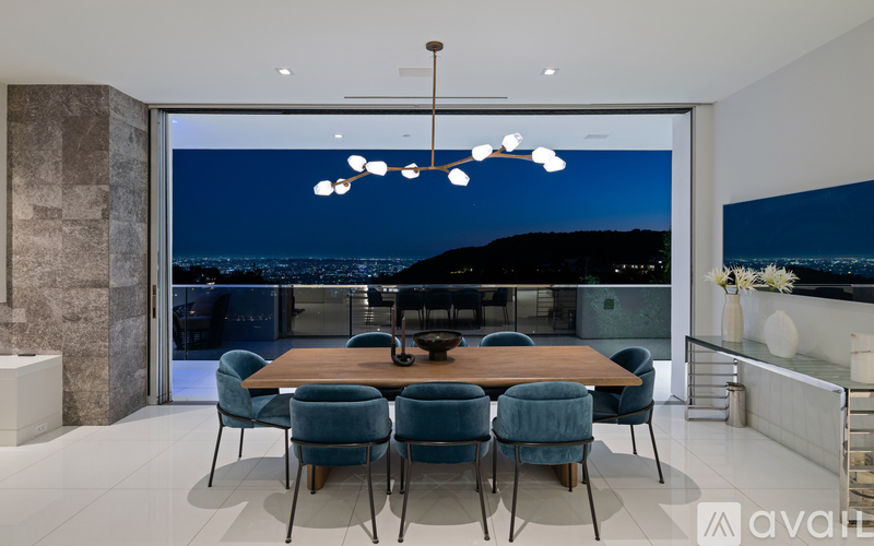 A modern dining room with a large table and chairs.
