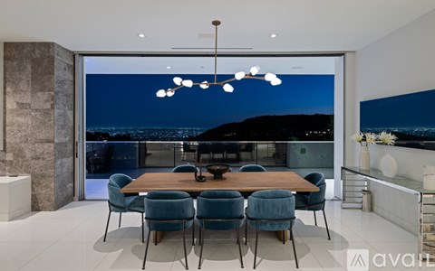 A modern dining room with a large table and chairs.