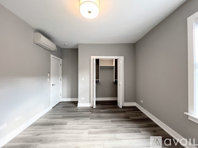 A spacious room with a doorway leading to another room.