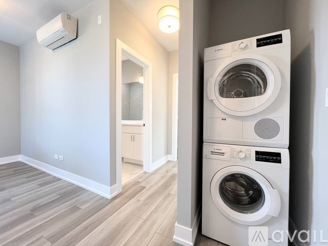 A white washing machine and dryer in a laundry room.