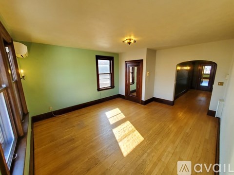A room with wooden floors and green walls.