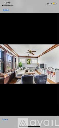 A living room with a ceiling fan and a couch.
