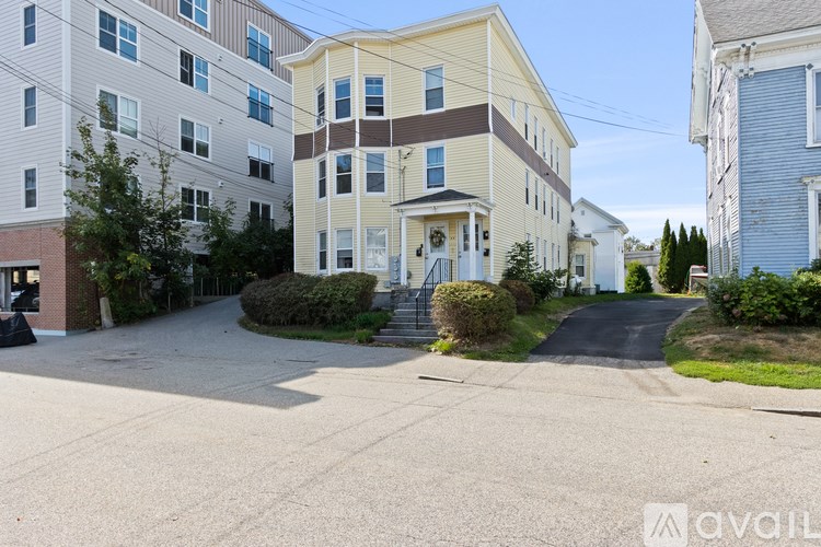 A street view of a residential area with apartment buildings.