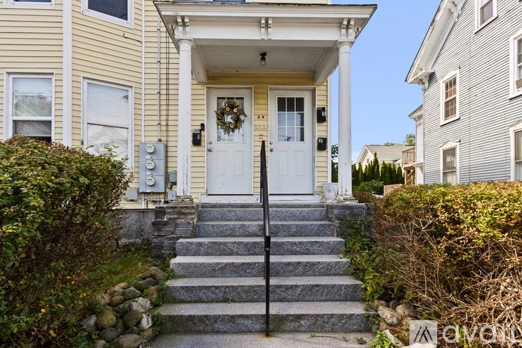 A house with a front door and steps leading up to it.