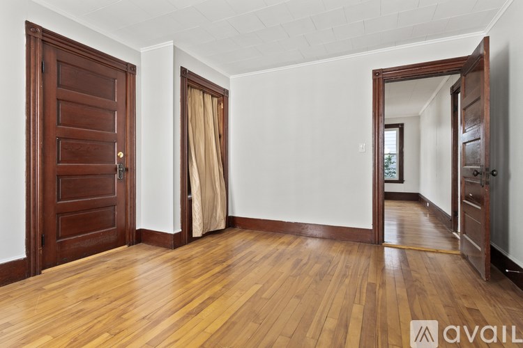 A room with wooden floors and a white wall.
