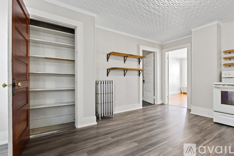 A room with a white ceiling and wooden floors.