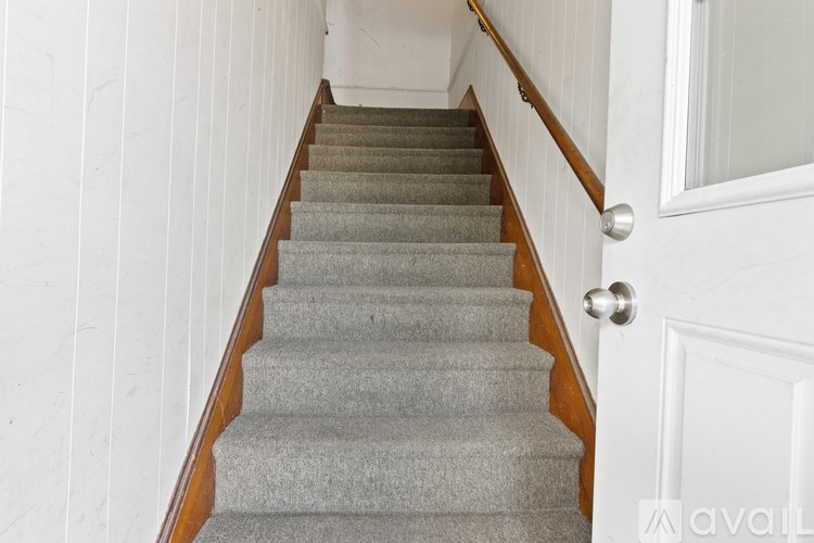 A staircase with a white door on the side.
