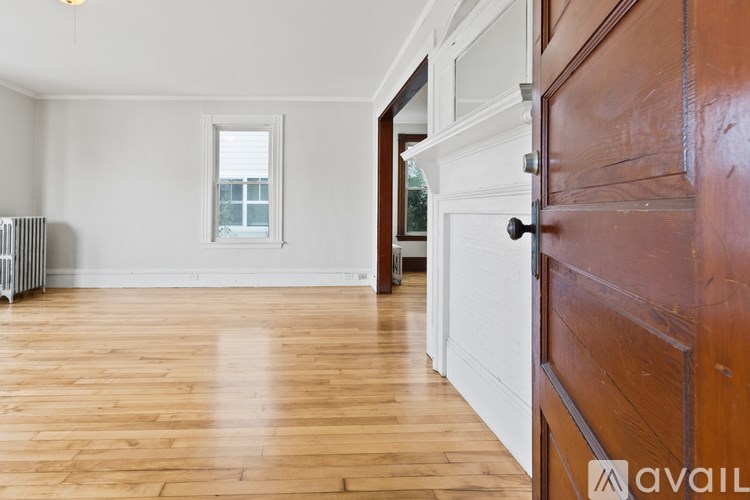 A room with wooden floors and a white door.