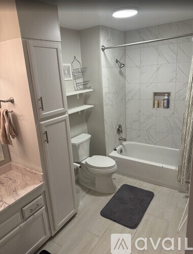 A bathroom with a toilet, sink, and bathtub.