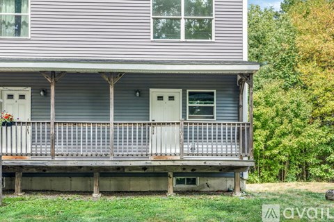 A house with a porch and a balcony.
