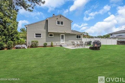 A house with a well-maintained lawn and a clear sky.