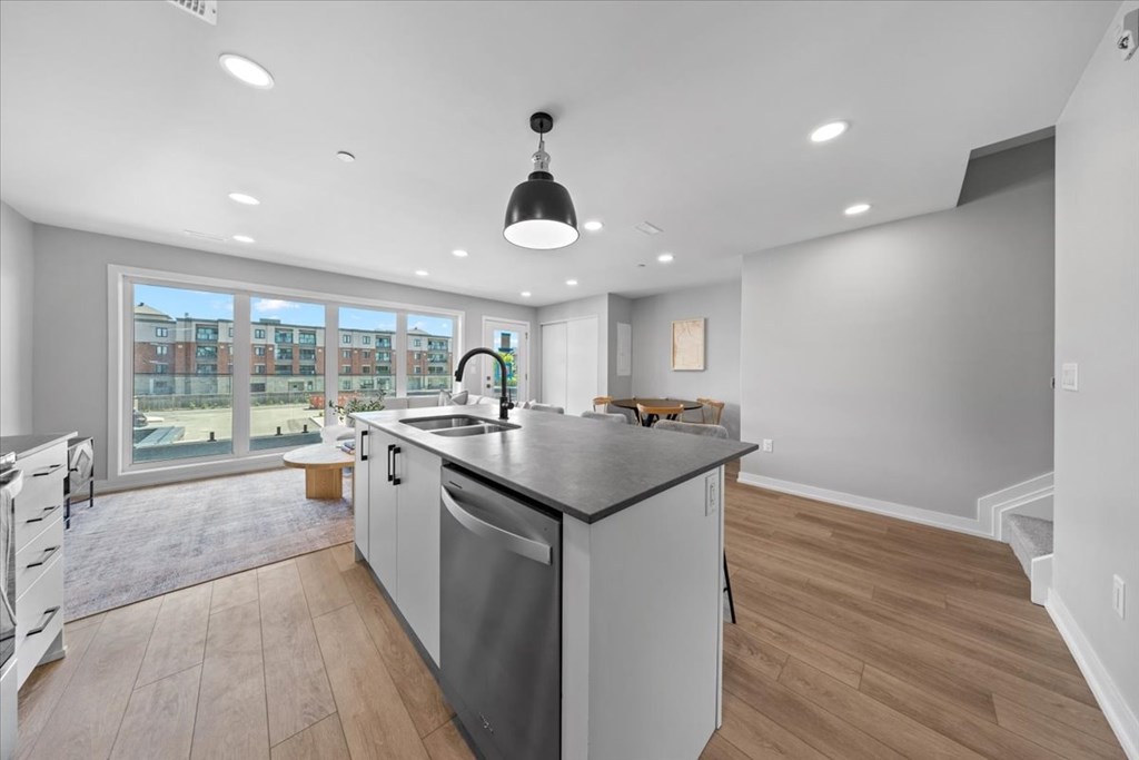 A modern kitchen with a large island and stainless steel appliances.