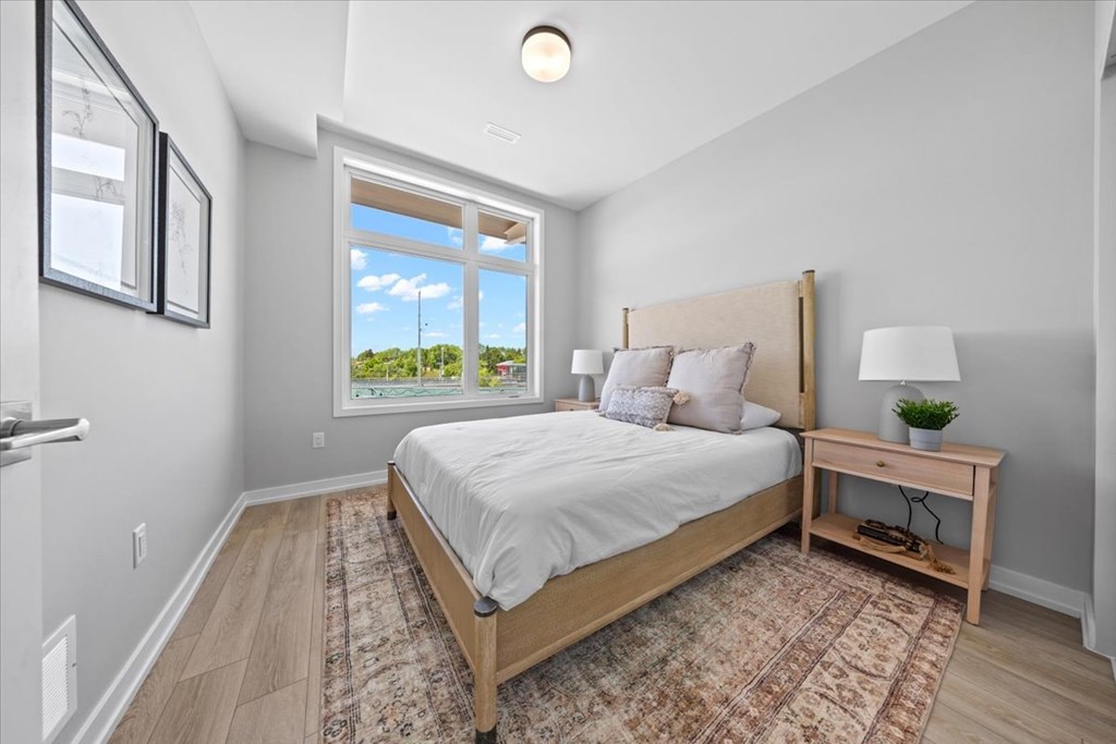 A bedroom with a large bed and a window overlooking the outdoors.