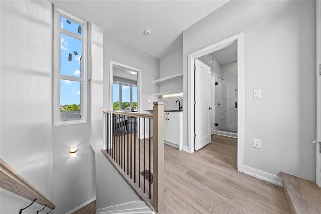 A white interior of a house with a staircase leading to the second floor.