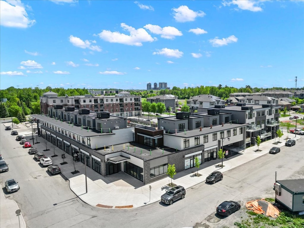 A parking lot with cars and a building in the background.