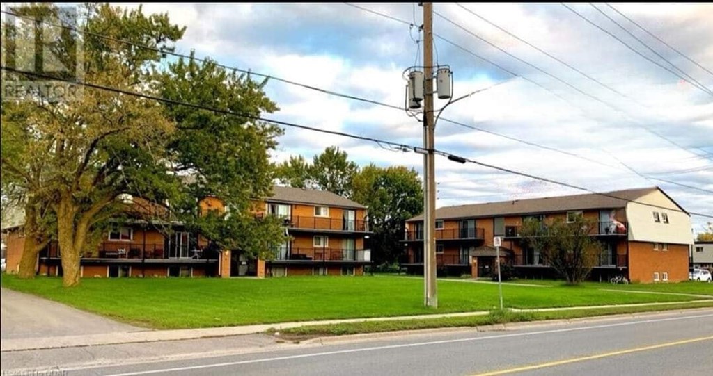 A street view of a residential area with apartment buildings.