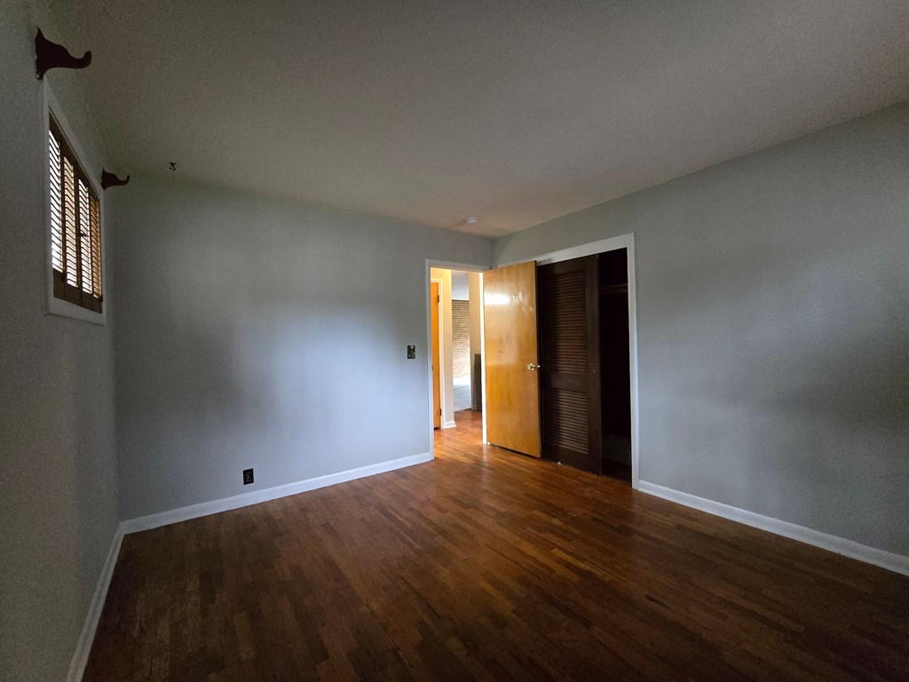 A room with wooden floors and a door.