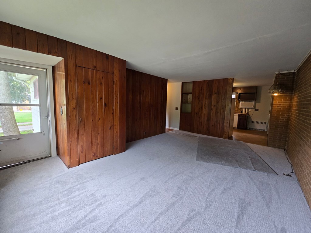 A room with wooden walls and a carpeted floor.