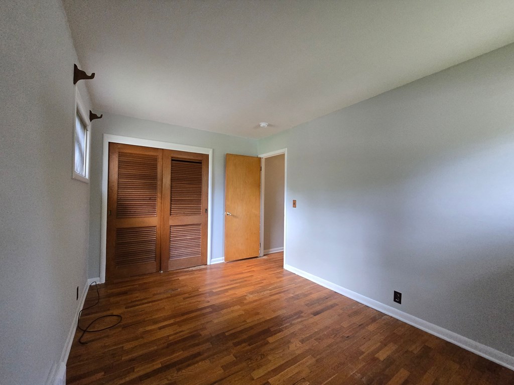 A room with wooden floors and white walls.