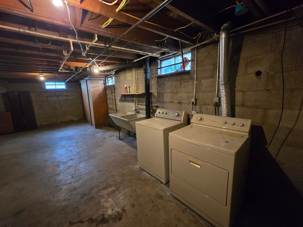 A room with a washer and dryer in it.
