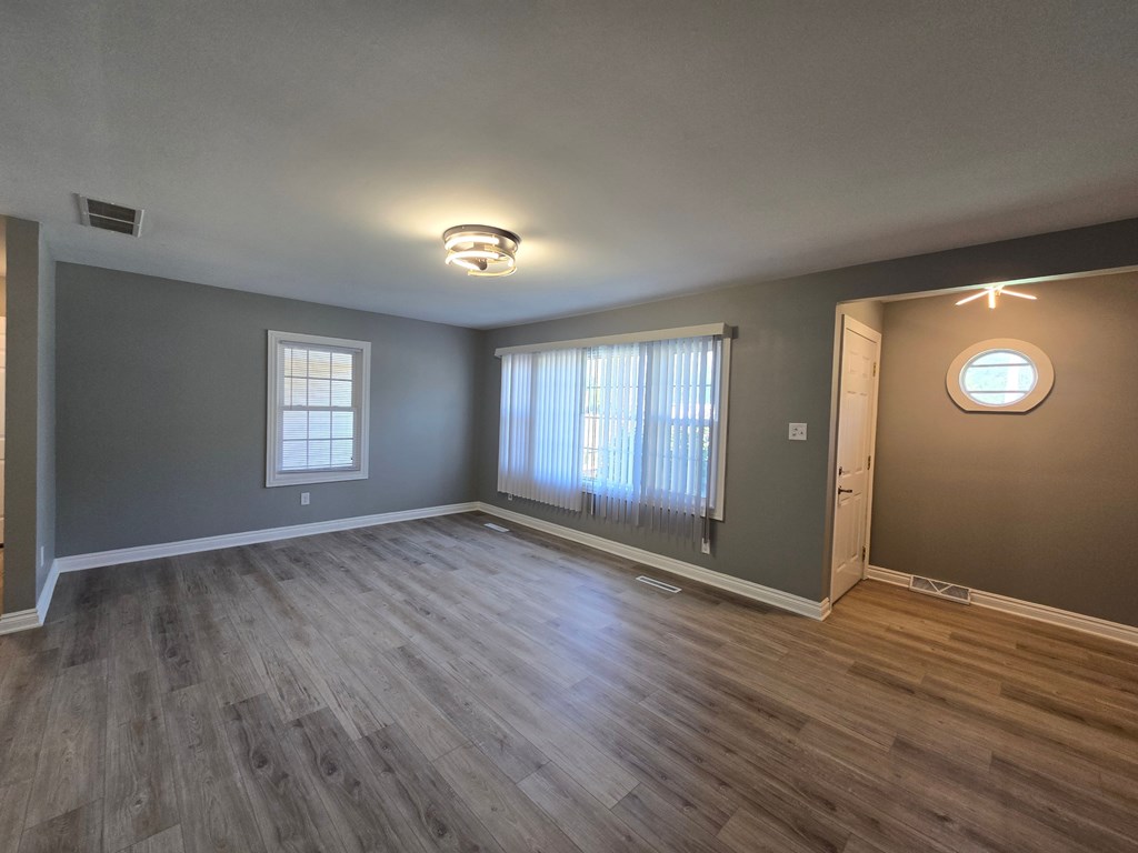 A room with a window and a door.