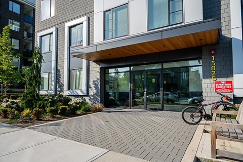 A modern building with a bicycle parked in front.