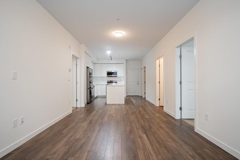 A long hallway with a kitchen at the end.