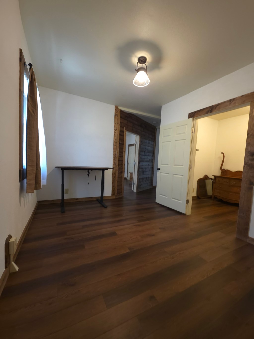 A room with a wooden floor and a white ceiling.