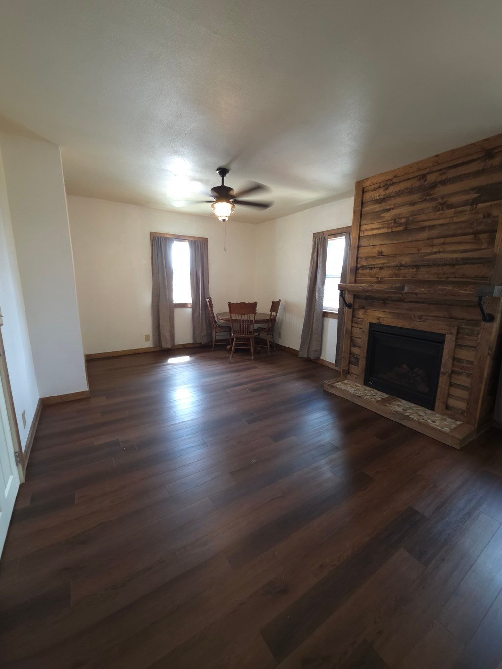 A room with wooden floors and a fireplace.