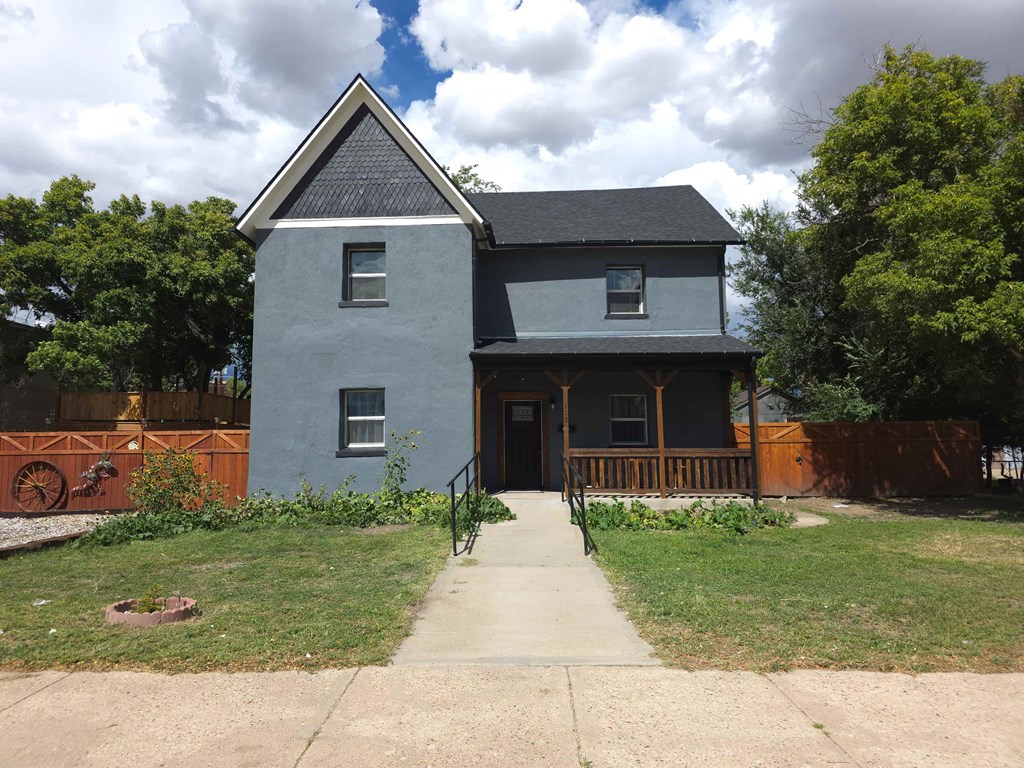 A house with a grey front and a black roof.