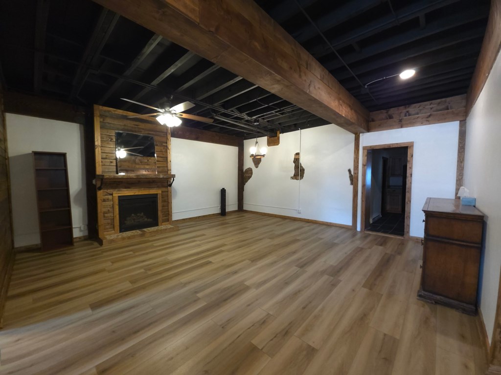 A room with wooden floors and a fireplace.