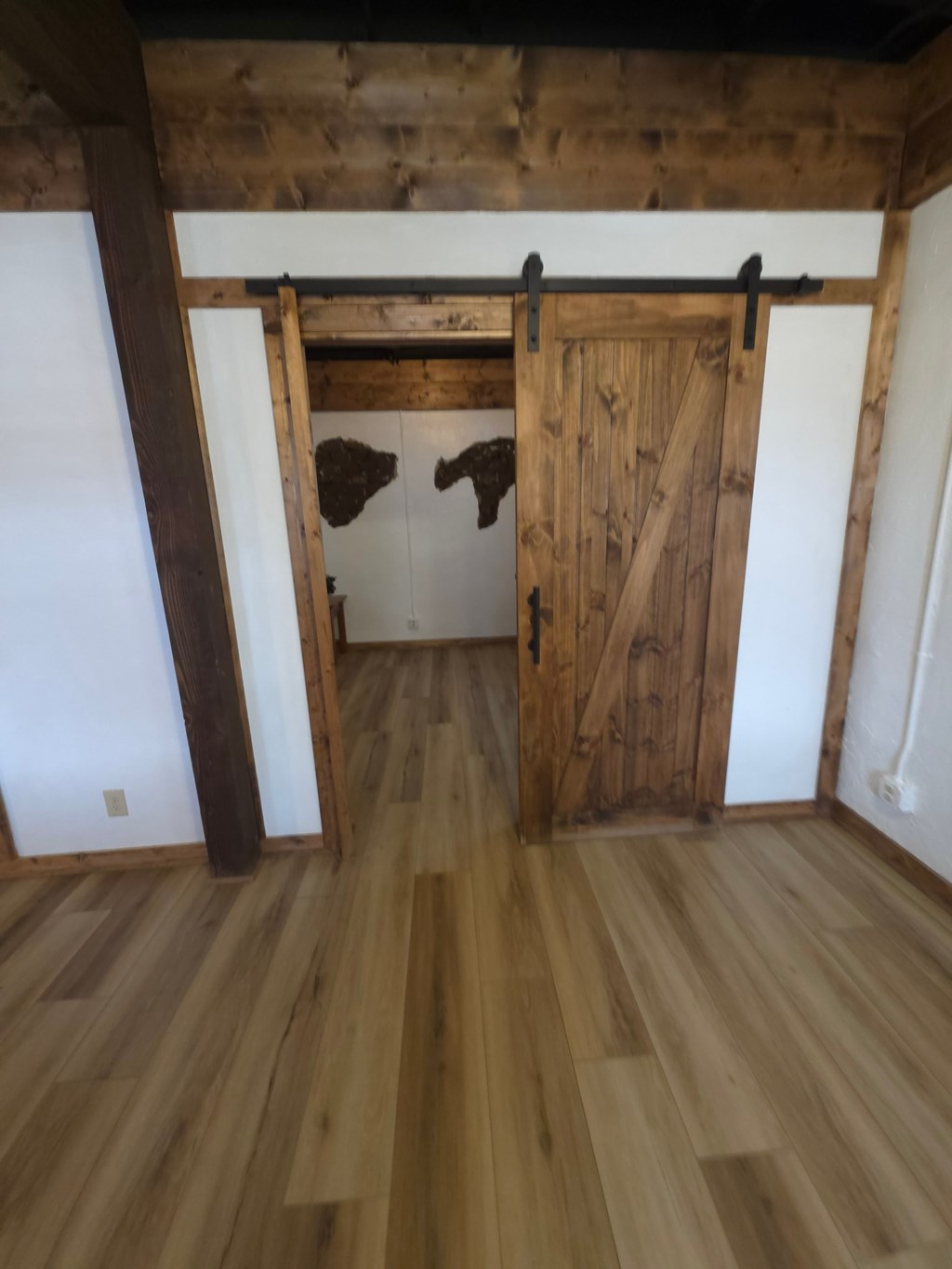 A room with wooden floors and a wooden door.