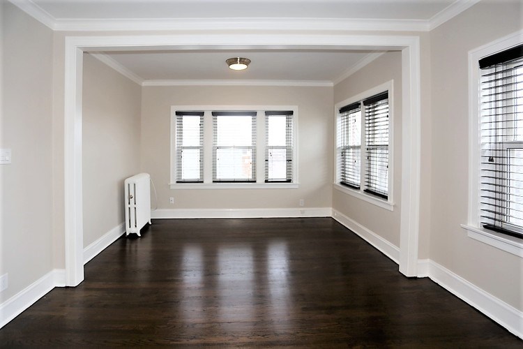 A room with wooden floors and white walls.