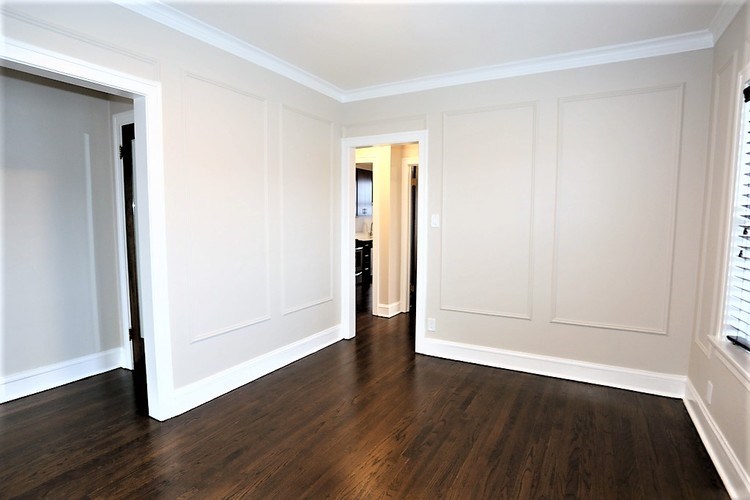 A room with white walls and wood flooring.