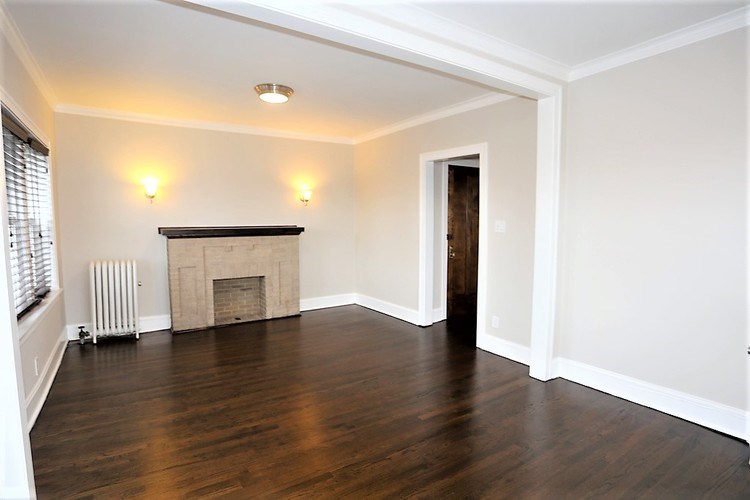 A room with a fireplace and a door.