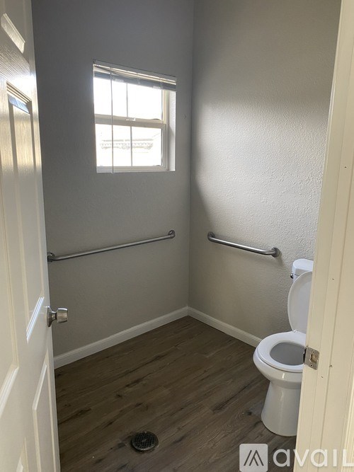 A small bathroom with a toilet and a window.