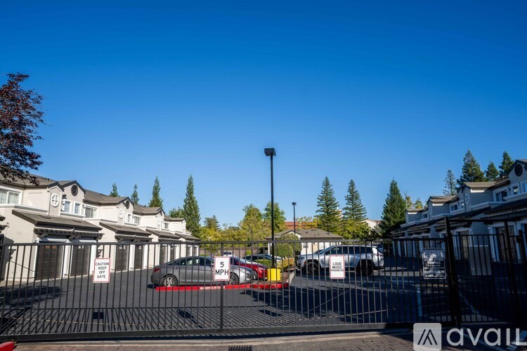 A gated community with a sign that says "available" in the foreground.