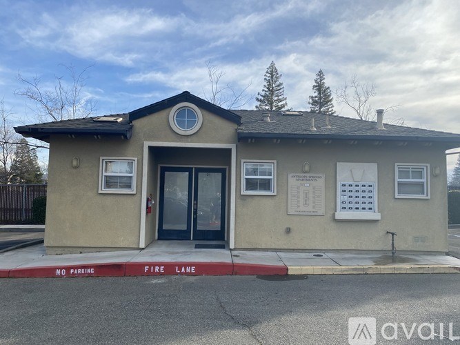 A small building with a red and white sign that says "NO PARKING FIRE LANE".
